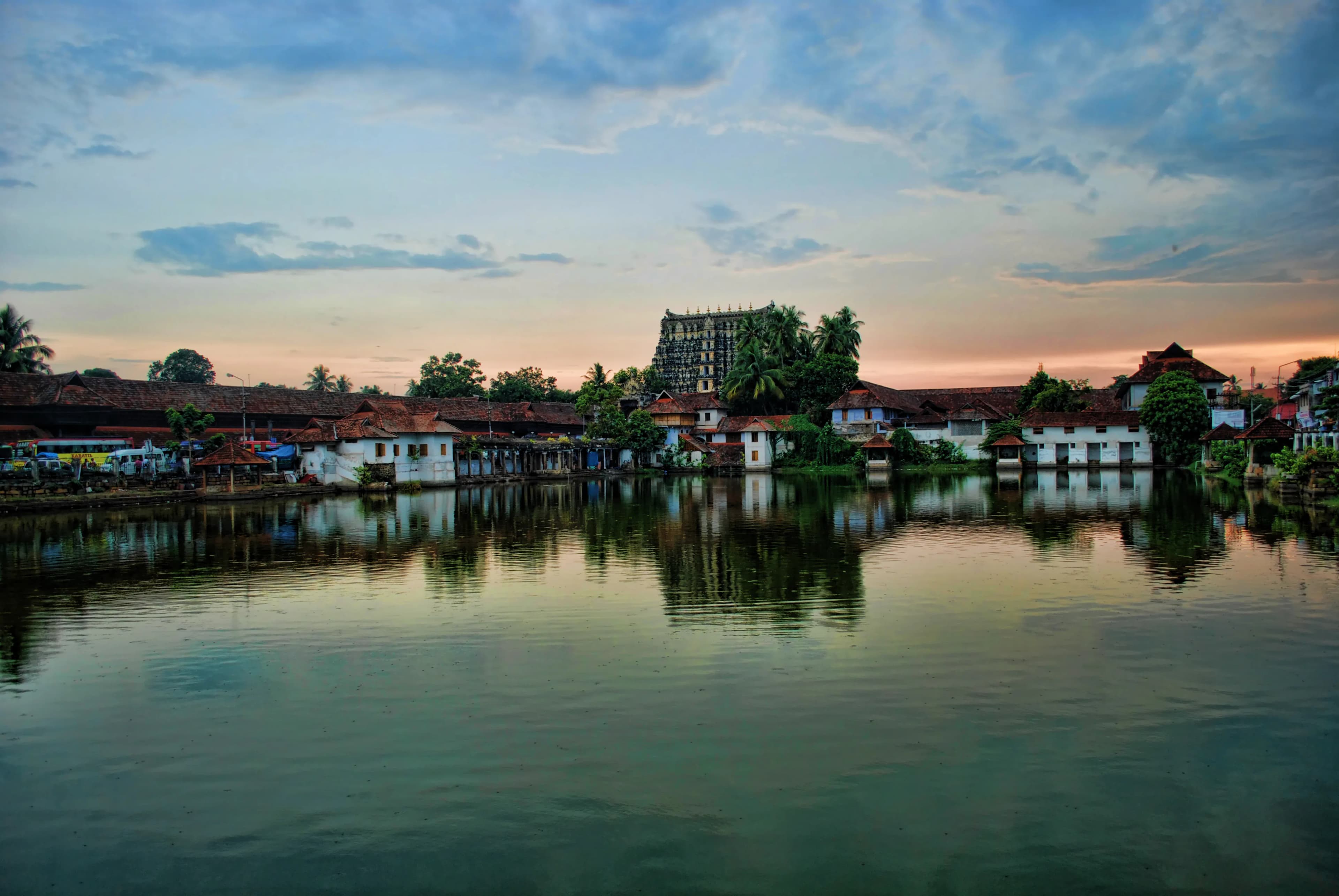 The imposing Gopuram of the Sree Padmanabhaswamy Temple, a symphony in Dravidian and Kerala architectural styles, pierced the Thiruvananthapuram skyline, its vibrant hues a stark contrast to the monso...