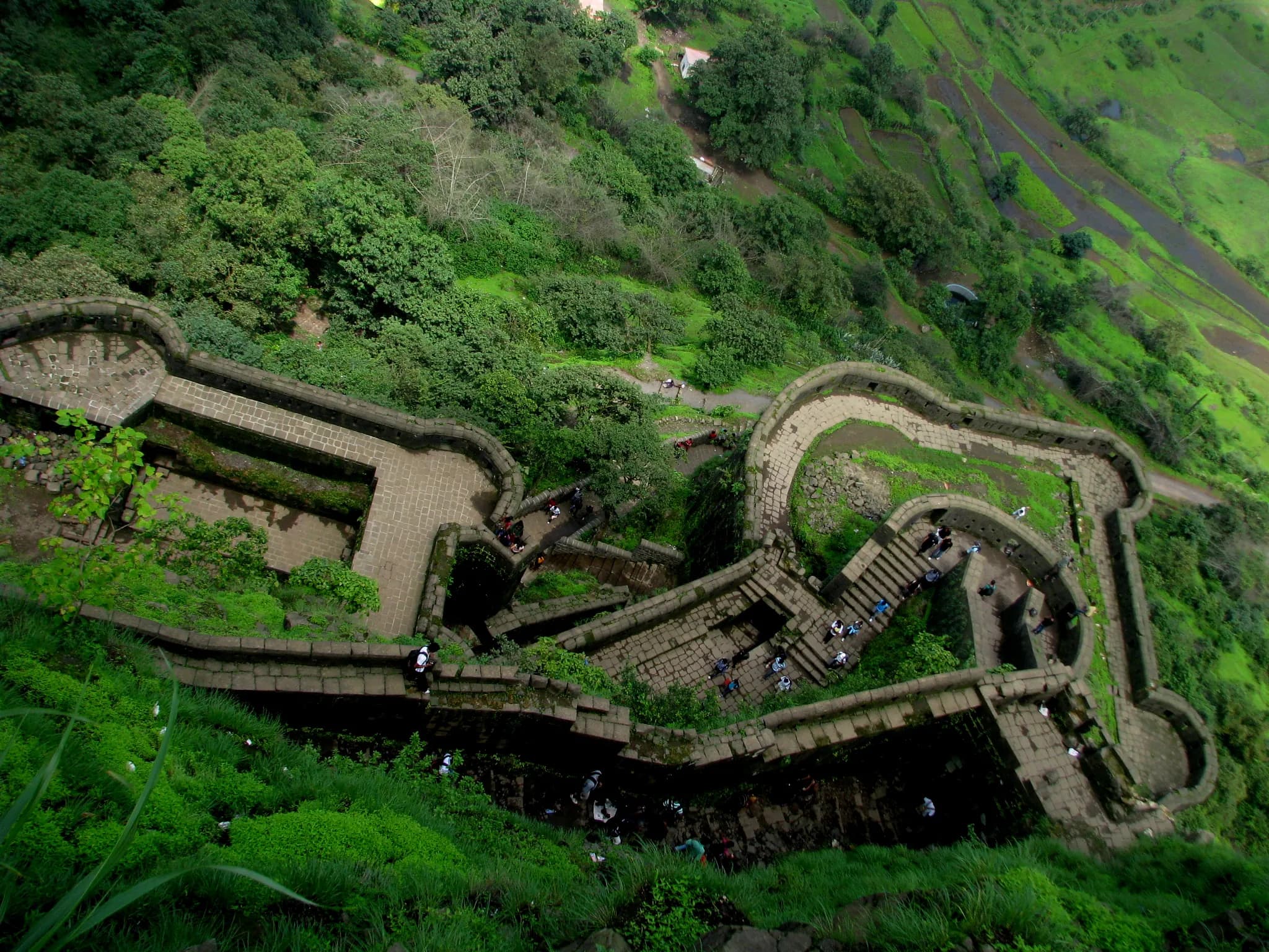 The wind whipped around me, carrying the scent of damp earth and wild grass, as I crested the final rise towards Lohagad Fort. Having explored countless Rajputana strongholds, from the majestic Mehra...